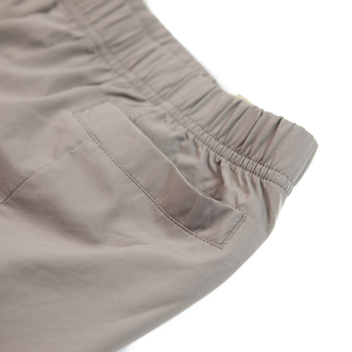 WMNS NSW Dri-FIT Tech Pack High-Rise Woven Trousers (Moon Fossil/Cave Stone)